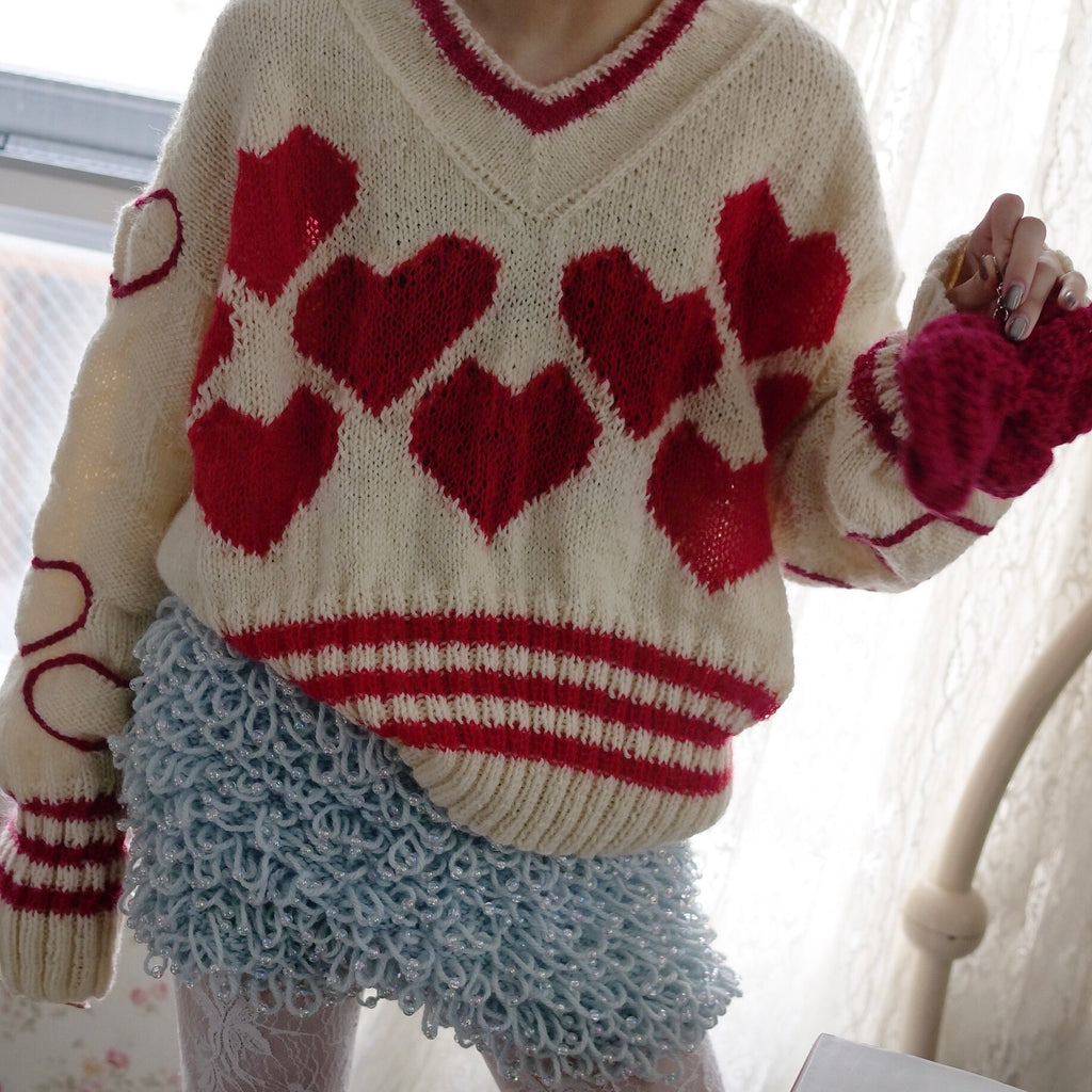 Hand-knitted sweater with lots hearts